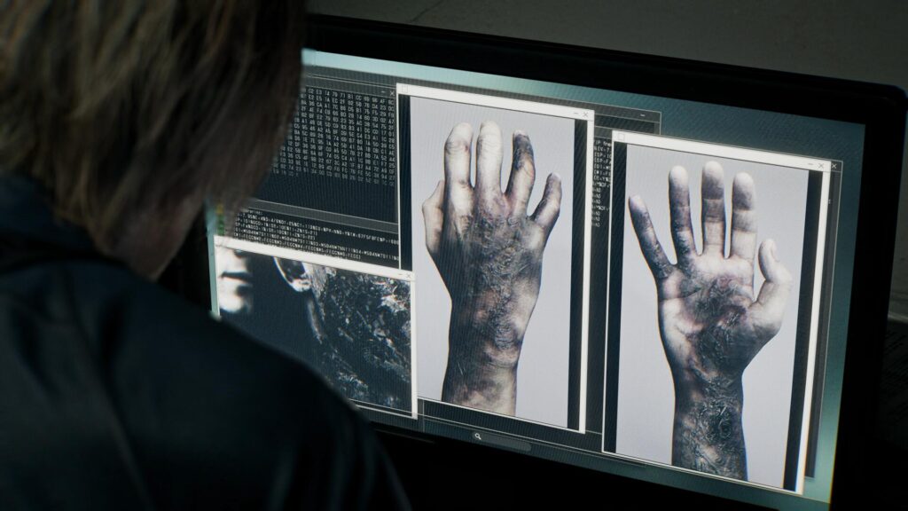 Leon Kennedy studying disturbing forensic images on a computer screen in Resident Evil Requiem, reflecting the game’s investigative storytelling and shared narrative between Leon and Grace Ashcroft.